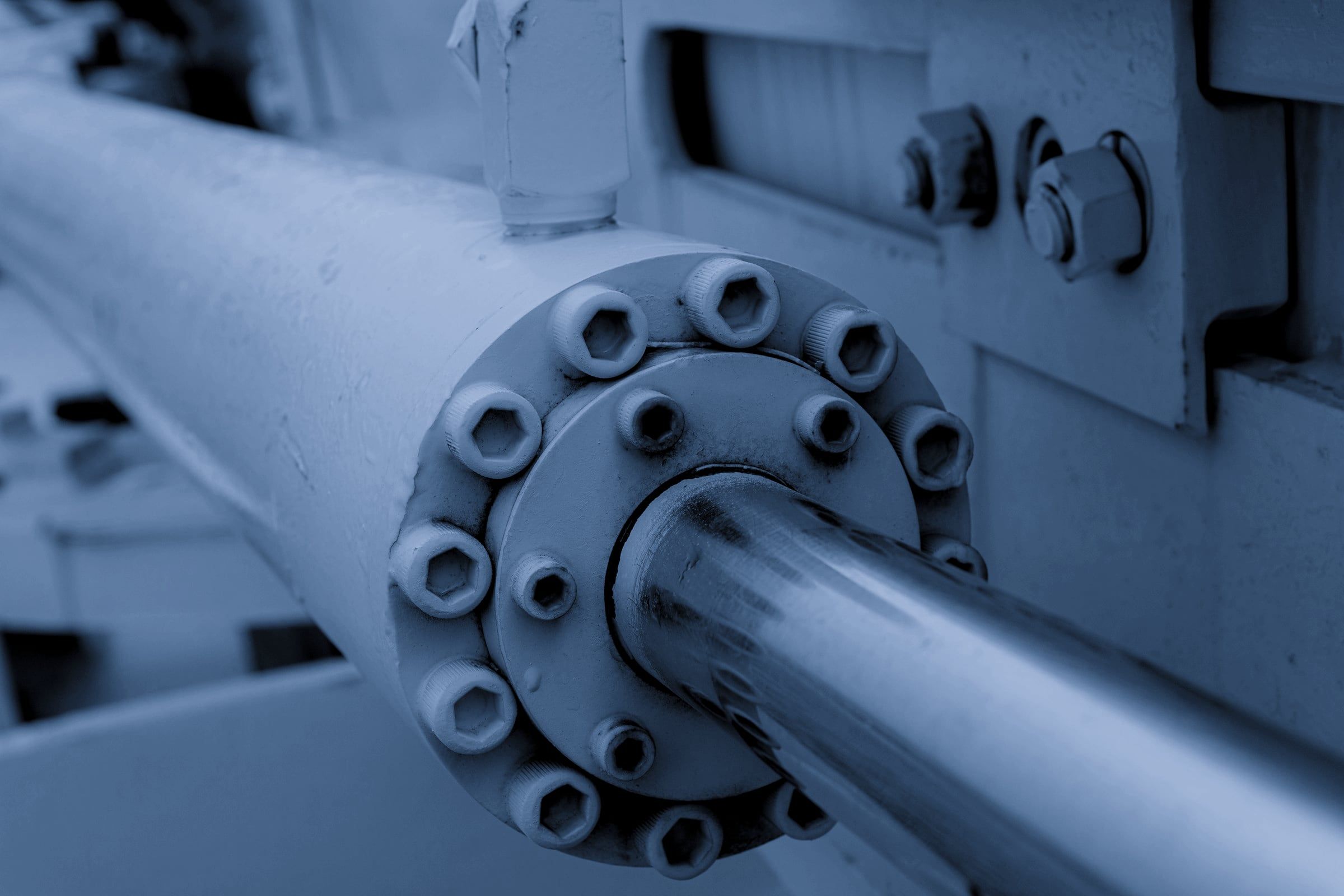 Close-up of a hydraulic cylinder rod and bolted gland
