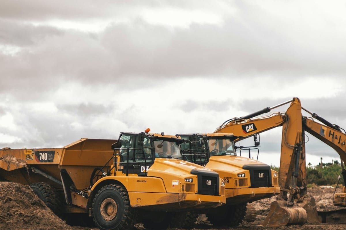 Excavator and articulated haul trucks on a jobsite